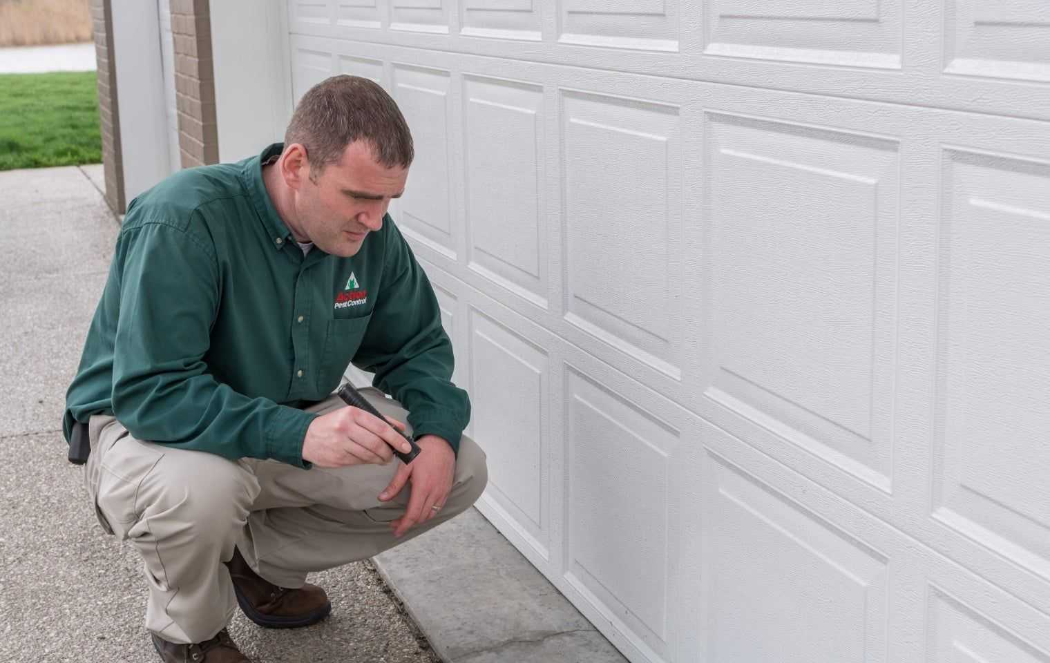 a tech inspecting a garage door