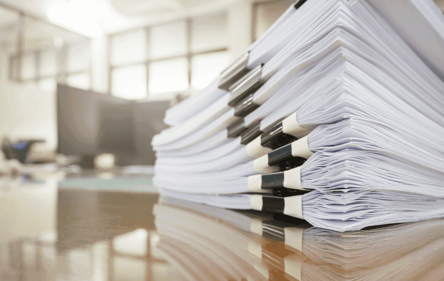 stacks of documents on a desk