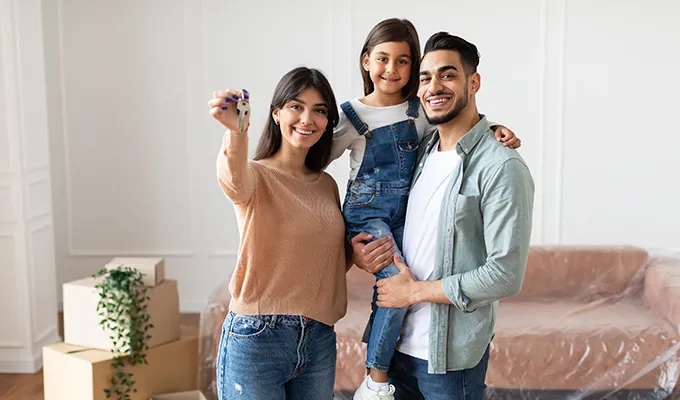 Family in a new home with keys to the house