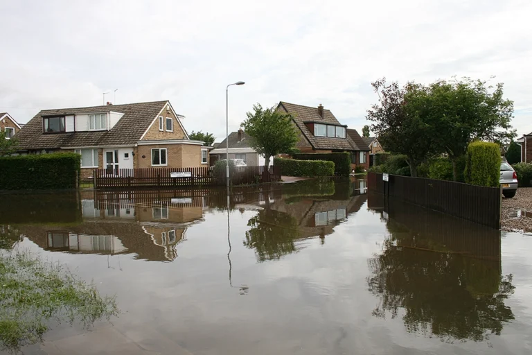 A residential neighborhood experiencing a high water flood.