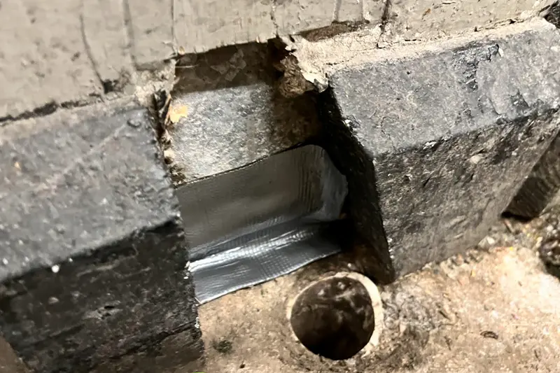 Flexi Armour tape being used by Suburban Exterminating to seal the gap space between structural expansion joints.