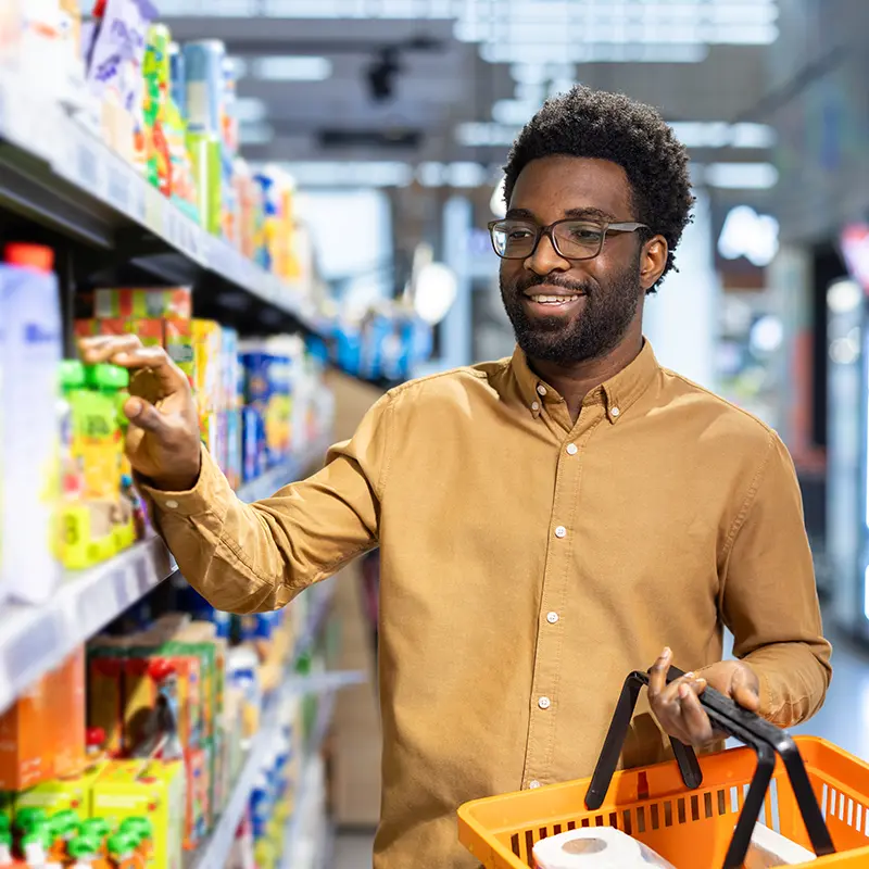 Man selecting item from shelf at pest-free Indiana convenience store