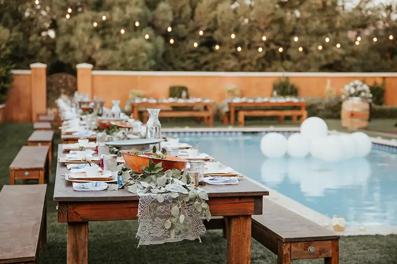 Suburban backyard with a pool and outdoor furniture.